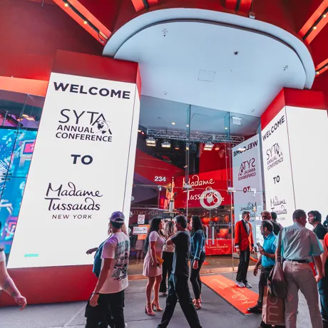 Outside view of Madame Tussauds with SYTA logo displayed on screens