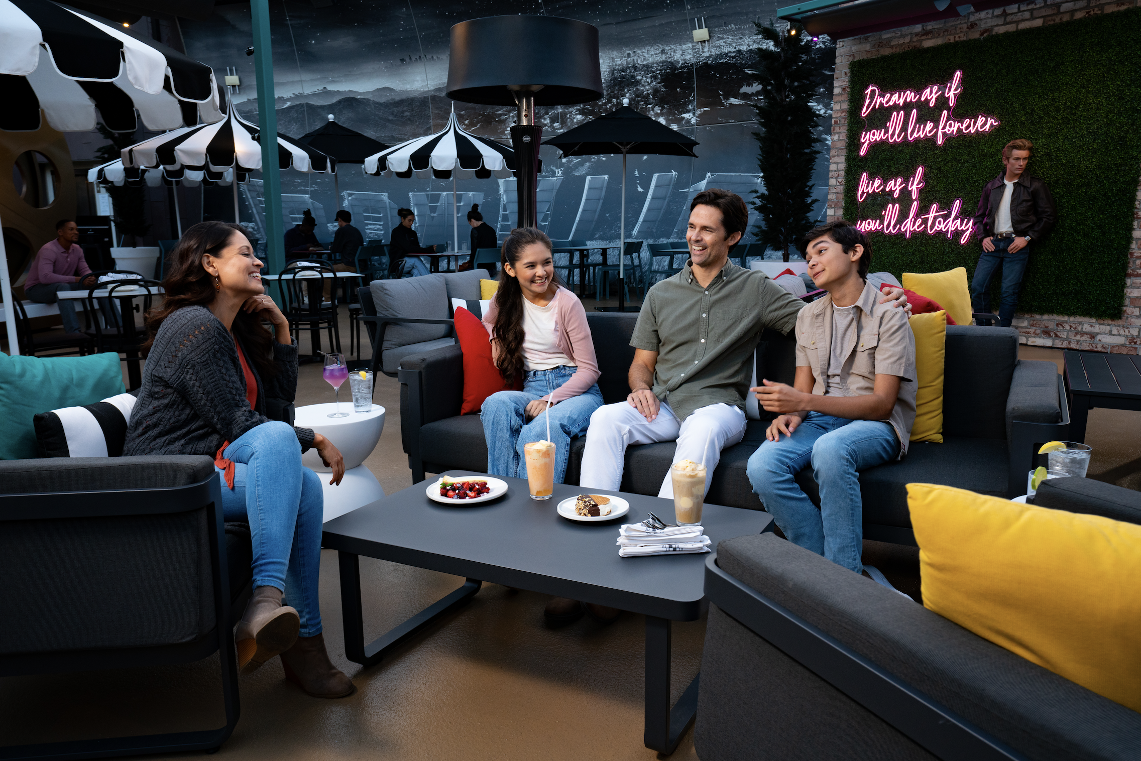 Family eating dessert at The Hollywood Rooftop Restaurant & Bar by Madame Tussauds