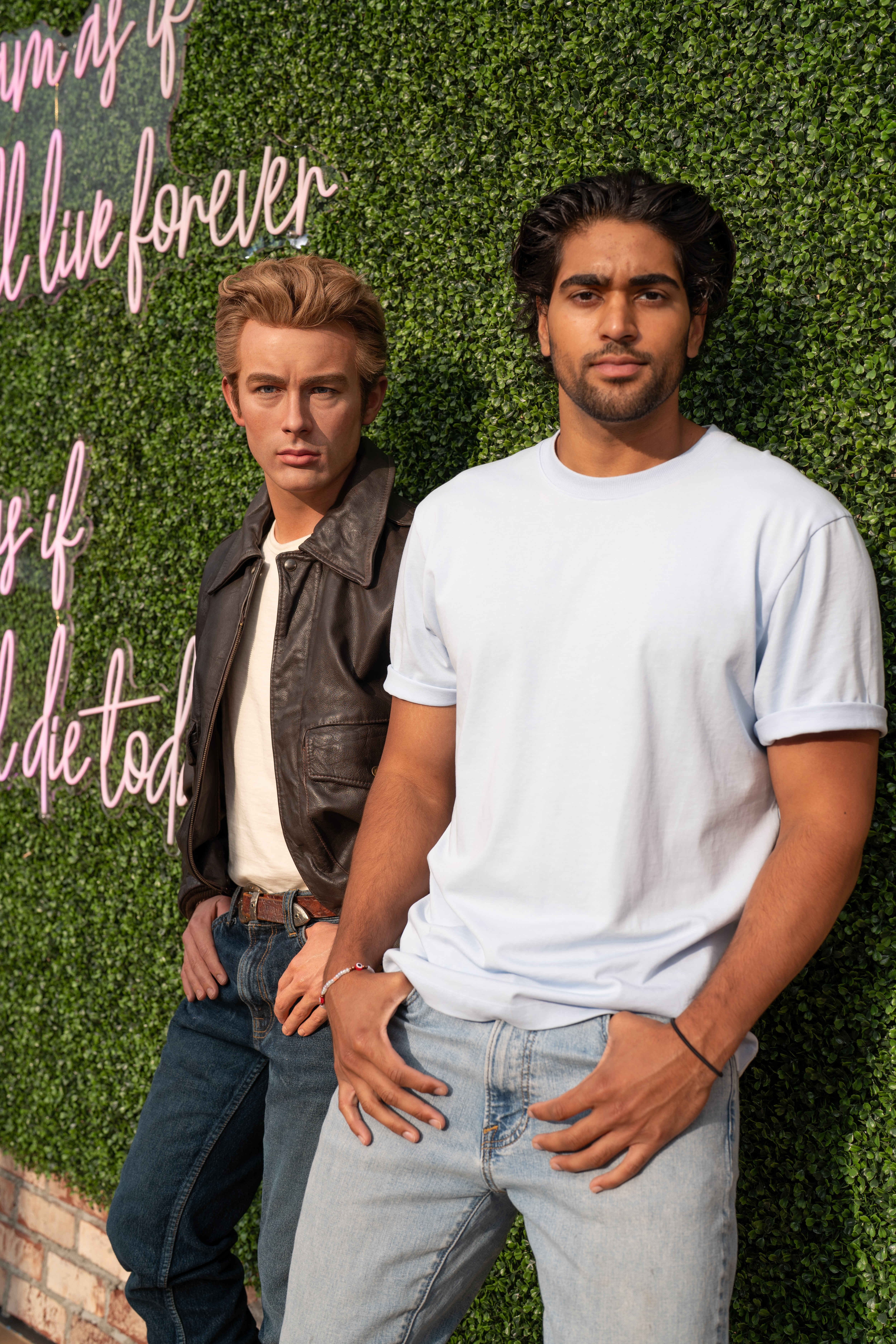 Man posing with James Dean wax figure