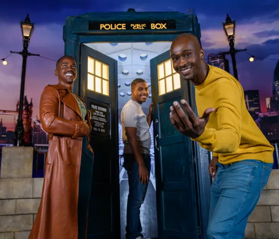 A man reaching out to the camera inviting you to join him, his son, and The Doctor into The TARDIS