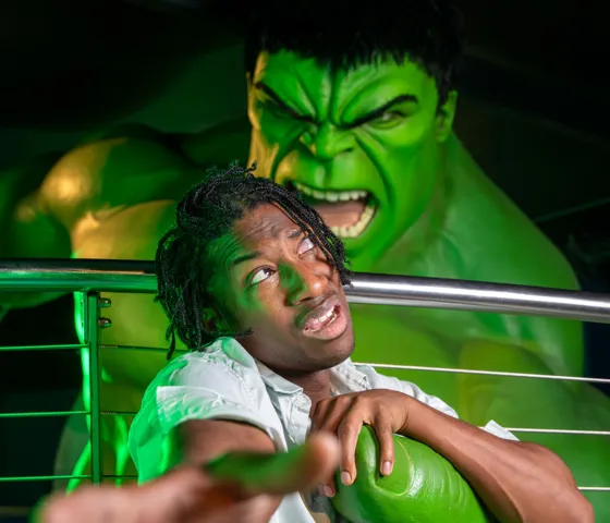 A person reaching out for help as they are being grabbed by The Incredible Hulk