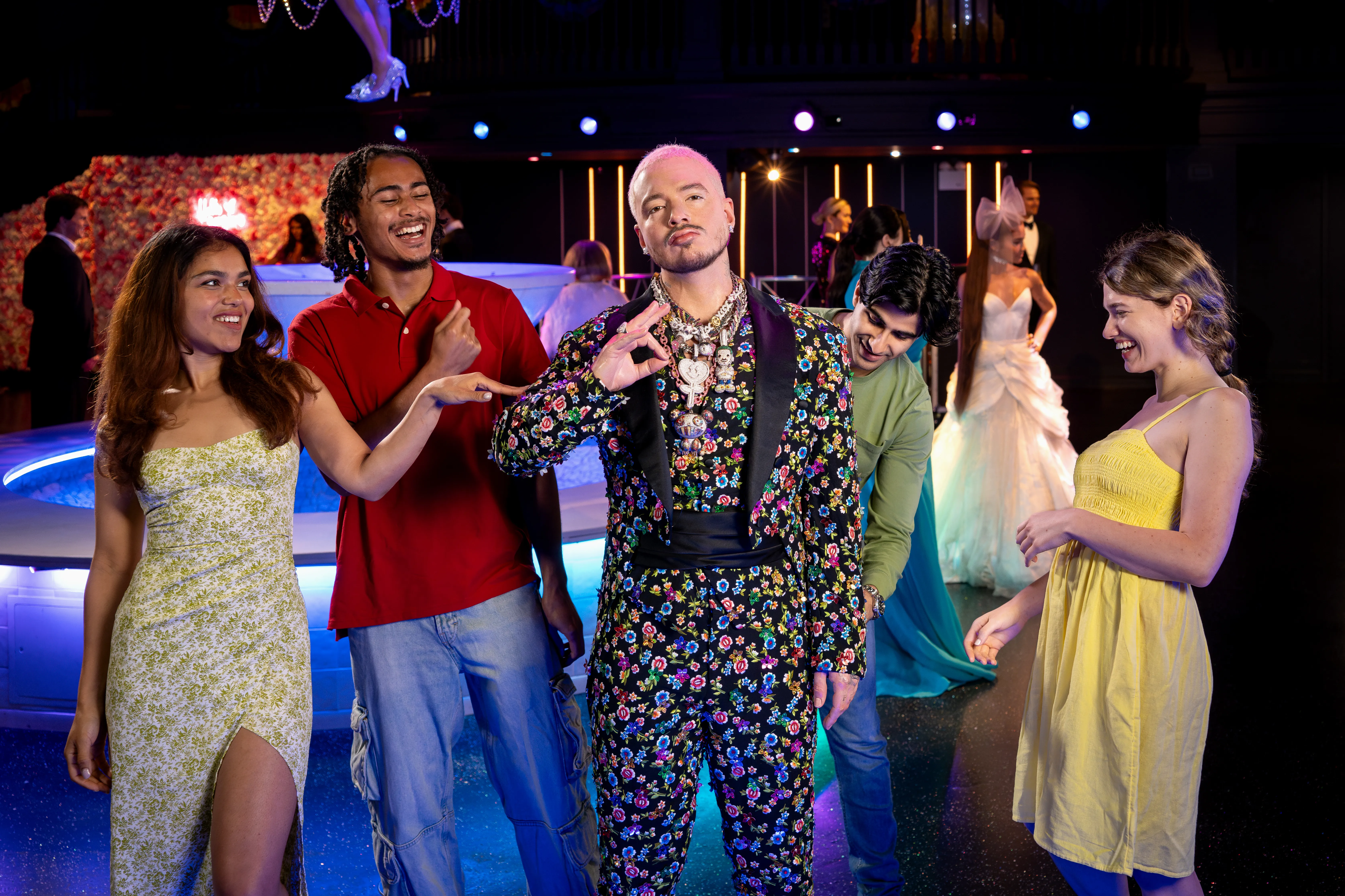 Group of friends with J Balvin wax figure at Madame Tussauds New York