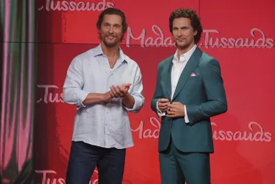 Actor Matthew McConaughey posing next to his wax figure at Madame Tussauds New York