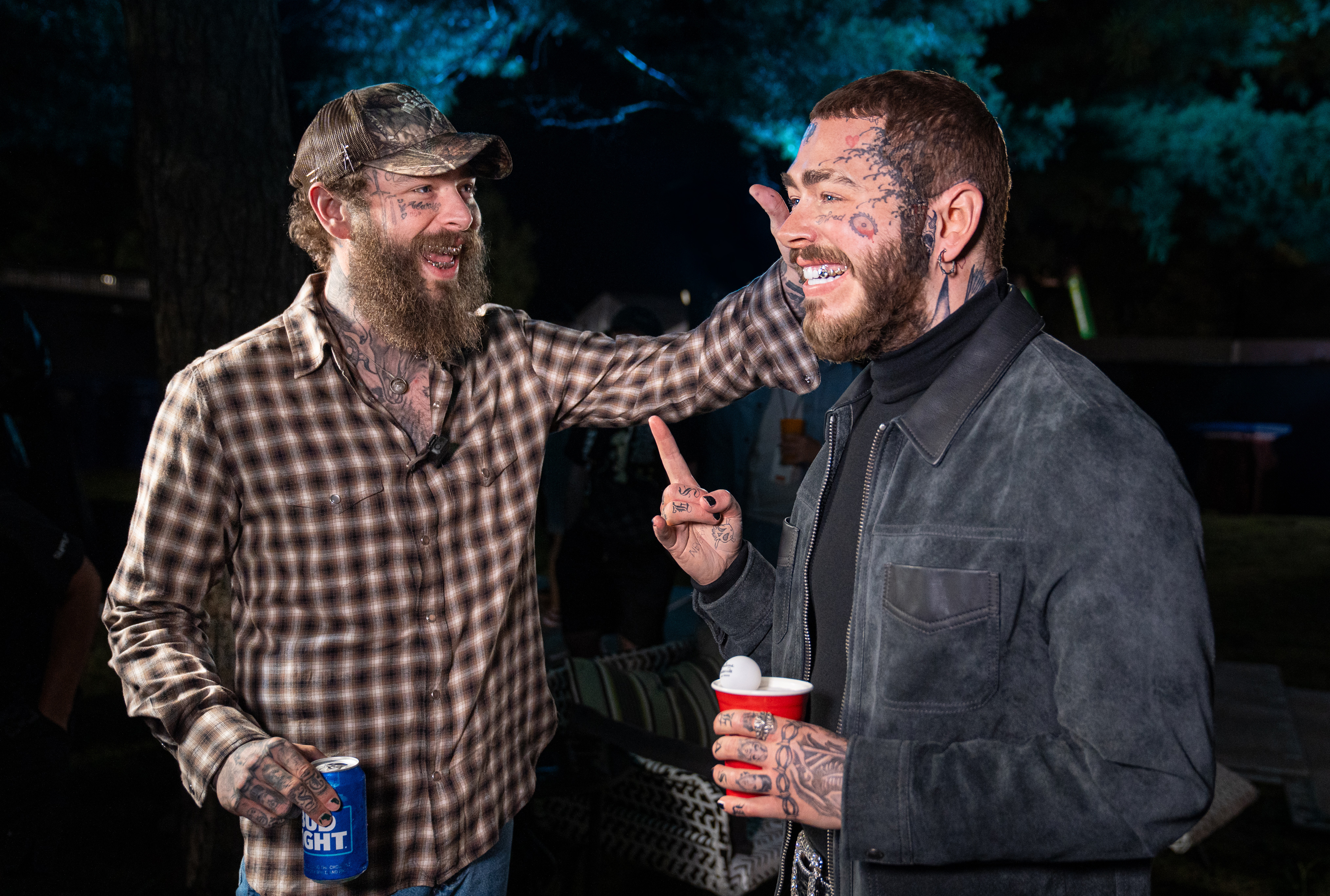 Post Malone excitingly looking at a wax figure of himself