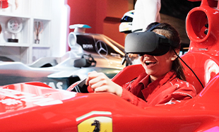 1 out of 5 experiences in Madame Tussauds Singapore. A person experiencing VR Virtual Reality car racing simulation with Lewis Hamilton's team.