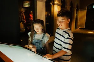 Student interacting with the multi-touch interactive screens at Images of Singapore