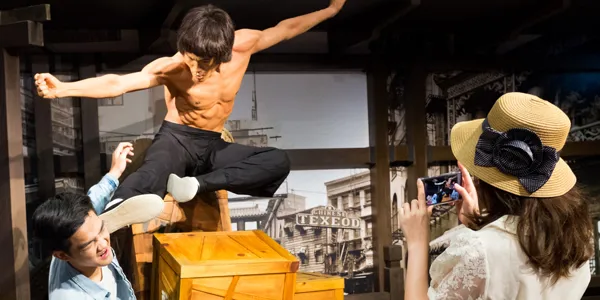 1 out of 4 experiences in Madame Tussauds Singapore. Tourist taking photo with Bruce Lee's wax figure.