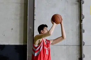 yao ming playing basket ball with child